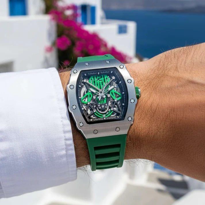 Green and silver watch on a wrist with a blurred outdoor background